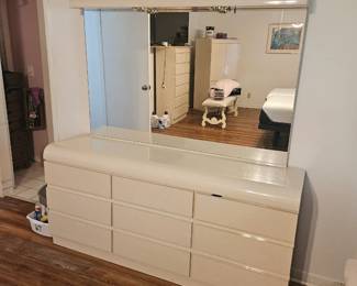 The master bedroom is at the end of the hall and the bedroom set is the style from the 80s. White formica