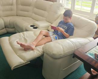 The white leather around sectional is 20 feet. From one end to the other has 3 electric recliners. Mint condition, pet free and smoke free $1200 they paid over eight thousand dollars several years ago