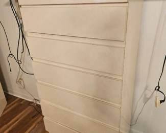 The set comes with he tall dresser. As shown, a long dresser with mirror, and a huge towering hey, board with built in mirror and storage behind where the pillows go with lights
