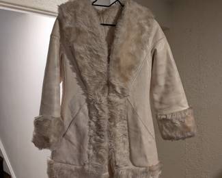 70s-style cream faux shearling coat with shaggy faux fur collar, cuffs and trim. Penny Lane boho look.