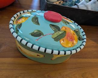 Droll Designs hand-painted oval covered baker with fruit design, turquoise with black and white striped rim. Colorful casserole dish.