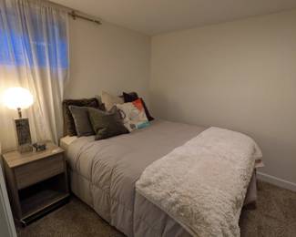 Full-size bed with mattress and frame. Throw pillows (set of 7). Cream faux fur throw (Mon Chateau). Glass table lamp with mirrored mosaic base. Silver metal elephant figurine.