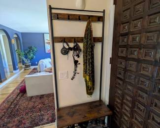 Industrial coat rack with bench and shoe storage, rustic wood and black metal. White faux deer head with gold antlers and red heart.