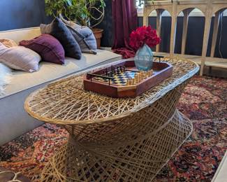 Woven wicker hourglass coffee table, boho mid-century style.