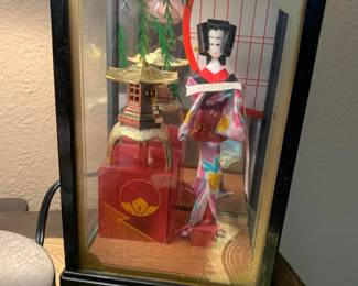 Glass encased Asian dolls