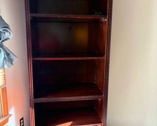 Vintage Broyhill Cherry Wood Illuminated Bookcase featuring a distinctive scalloped top valance, traditional fluted side moldings, and adjustable shelving