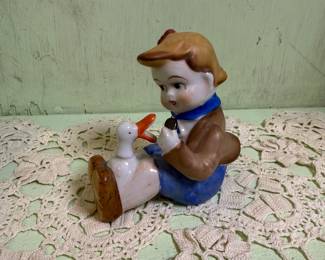 Boy with duck figurine