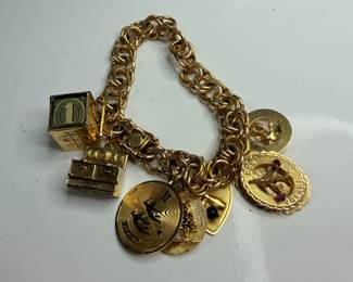 14 karat gold charm bracelet. All charms and chain marked 14 karat.