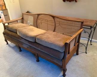 Vintage cane back sofa w/ cushions.