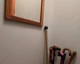 Antique oak mirror & canes. Stone ware crock.