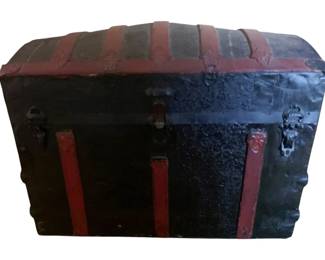817 - Metal & WoodDome Top Trunk 25"x34"x20" (Description): A vintage metal and wood trunk featuring decorative banding and hardware. Measures 25 inches wide by 34 inches long by 20 inches tall.