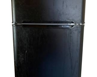 1025 - RCA Mini Fridge 33"x19"x21" (Description): RCA mini fridge featuring a two-door design with separate freezer compartment on top. This compact refrigerator measures 33 inches tall by 19 inches wide by 21 inches deep, making it ideal for dorm rooms, offices, or small spaces. Used as-is electric/electronic/mechanical item. No guarantee all components present, untested if not otherwise stated.