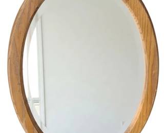 1080 - Wood Framed Mirror 22"x32" (Description): A wood framed mirror featuring an oval shape with a warm-toned wooden frame. Measures 22 inches by 32 inches.