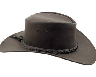 703 - Jacaru Med-Lrg Leather Hat (Description): Jacaru medium-large hat. This Australian-style hat features a braided leather band around the crown with metal eyelets for ventilation. The hat is designed in the classic outback style with a wide, curved brim.