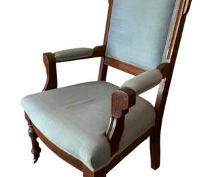 725 - Victorian Walnut Upholstered Arm Chair (Description): Antique Victorian chair featuring upholstered seat, back, and armrests. The chair showcases classic Victorian styling with carved wooden frame and turned legs. Measures 40 inches high by 22 inches wide by 20 inches deep.