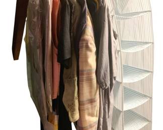 820 - Group Lot of Vintage Clothes (Description): A group lot of vintage clothes featuring an assortment of garments on hangers. The collection includes various styles and colors representative of vintage fashion.