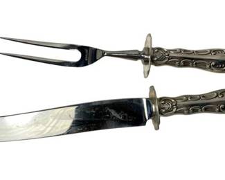 2023 - Gorham Strasbourg Sterling Handle Serving Set (Description): A two-piece Gorham serving set featuring ornate sterling silver handles. The set includes a carving knife and a two-tined serving fork, each with decorative scrollwork on the handles. Measures 10 inches in length.
