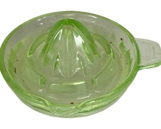 1052 - Uranium Glass Juicer 3"x7" (Description): Uranium glass juicer measuring 3 inches by 7 inches. This vintage kitchen tool features the characteristic green glow of uranium glass and includes a pour spout for easy use.