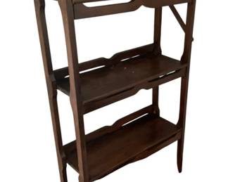 726 - 3 Tier Wood Bookshelf 43"x23"x9" (Description): Three tier wooden bookshelf featuring a decorative carved crest at the top. This freestanding shelving unit provides practical display and storage space. Measures 43 inches tall by 23 inches wide by 9 inches deep.