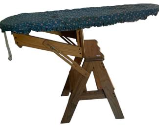 707 - Wooden Ironing Board Step Stool (Description): Wooden ironing board that converts to a step stool. This versatile piece features a solid wood construction with an A-frame folding design. The ironing surface is covered with a blue floral fabric cover.
