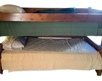738 - Wood Bunk Bed w/ Bedding 52"x42"x82+" (Description): Wood bunk bed with bedding included. The bed features a sturdy wooden frame construction. Measures 52 inches wide by 42 inches deep by 82+ inches tall.