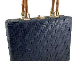 785 - Wicker Bag w/ Bamboo Handle 14"x11"x3" (Description): A wicker bag featuring a bamboo handle with gold-tone hardware. The bag showcases a woven herringbone pattern. Measures 14 inches by 11 inches by 3 inches.