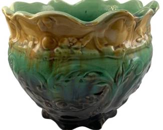 261 - Majolica Pottery Planter 8"x10" (Description): Pottery planter featuring a scalloped rim and decorative molded design. The piece displays a multicolor glaze that transitions from green at the top through teal to dark brown at the footed base. Measures 8 inches by 10 inches.