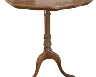 320 - Vintage Mahogany Scalloped Tea Table (Description): Scalloped wood table featuring a decorative raised edge and turned pedestal base with tripod legs. Measures 29 inches by 24 inches.