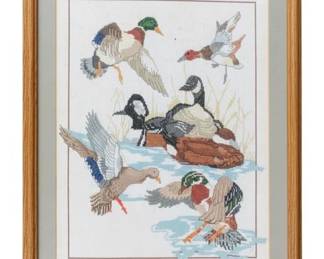 1059 - Birds Needlepoint Framed 22.5"x17.5" (Description): Framed needlepoint featuring birds in flight. The piece depicts various waterfowl including ducks in a naturalistic setting with sky and marsh grass elements. Professionally matted and presented in a wooden frame. Measures 22.5" x 17.5".