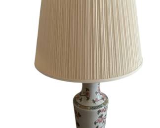 337 - Oriental Lamp 36" (Description): Oriental lamp featuring a porcelain vase-style base with painted cherry blossom and floral motifs on a cream ground. The base is mounted on a dark wooden pedestal and topped with a pleated fabric shade. Measures 36 inches in height. Used as-is electric/electronic/mechanical item. No guarantee all components present, untested if not otherwise stated.