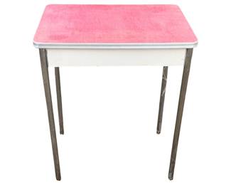 1061 - Vintage Table 29"x24.5"x17.5" (Description): Vintage table featuring a pink laminate top with chrome edging and tapered metal legs. The table has a white apron beneath the tabletop. Measures 29 inches tall by 24.5 inches wide by 17.5 inches deep.
