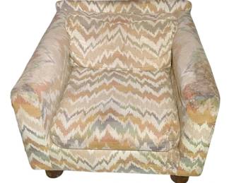 1135 - Vintage Chair 26"x33"x33" (Description): Vintage upholstered armchair featuring a flame stitch pattern fabric in muted earth tones. The chair has a comfortable cushioned seat and back with padded arms, resting on wooden bun feet. Measures 26 inches wide by 33 inches deep by 33 inches tall.