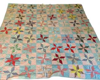 832 - Vintage Hand Stitched Quilt 83"x76" (Description): Handmade quilt featuring a colorful eight-pointed star pattern. The quilt showcases a variety of fabric prints and colors arranged in a traditional patchwork design. Measures 83 inches by 76 inches. Normal wear.
