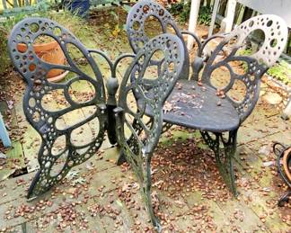 1126 - Pair Butterfly Chairs (AS-IS) 36"x26"x18" (Description): Two piece butterfly chairs sold as-is. These decorative outdoor chairs feature ornate butterfly-shaped backs with pierced circular designs. Each chair measures 36 inches high by 26 inches wide by 18 inches deep.