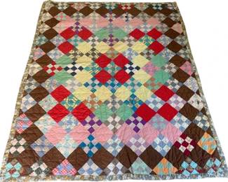 831 - Vintage Hand Stitched Quilt 72"x59" (Description): Handmade quilt featuring a patchwork design with a variety of colorful fabric squares arranged in a diamond pattern. The quilt incorporates brown solid fabric as a framing element with multicolored printed and solid cotton pieces throughout the center. Measures 72 inches by 59 inches. Normal wear.