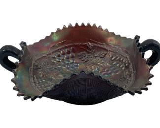 274 - Northwood Grape & Cable 2 Handle Nappy (Description): Carnival glass dish featuring an iridescent finish with grape and leaf motif. The dish has a sawtooth rim edge, twin handles, and a basketweave pattern on the base. Measures 2 1/4 inches by 7.25 inches.