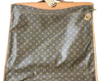 830 - Vintage Louis Vuitton Garment Bag (Description): Louis Vuitton clothes bag featuring the classic monogram canvas with leather trim. The garment bag includes a zippered exterior pocket and brass hardware closure. Measures 22 inches by 23 inches by 4 inches.