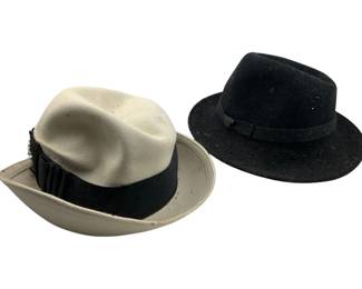 687 - Group of 2 Medium Hats (Description): Group of two medium hats. The lot includes two felt fedora-style hats, one in cream with a black ribbon band and one in black with a matching grosgrain band.