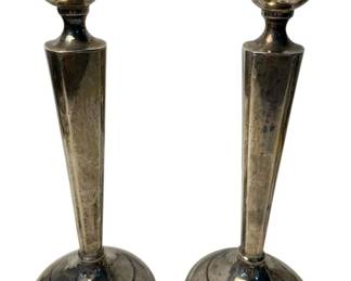 2009 - Pair Weighted Sterling Candlesticks 8"x2.75" (Description): A pair of sterling silver candlesticks measuring 8 inches tall with a base diameter of 2.75 inches. The candlesticks feature elegant tapered stems rising from stepped circular bases, topped with urn-shaped candle cups. 472g