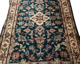 733 - Area rug measuring 105" x 63"- has damage as