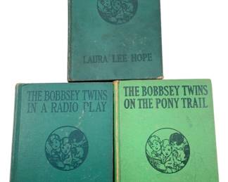 867 - Group Lot of 3 The Bobbsey Twins Books (Description): A group lot of three The Bobbsey Twins books by Laura Lee Hope, published by Grosset & Dunlap. The collection includes "The Bobbsey Twins on the Pony Trail," "The Bobbsey Twins in a Radio Play," and "The Bobbsey Twins in the Land of Cotton." The books feature hardcover bindings in varying shades of green with some wear consistent with age.