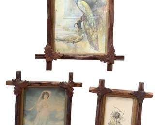 718 - 3 Vintage Criss Cross Carved Wood Frames (Description): A set of three decorative carved wood frames featuring crossed corner design with leaf motifs. Largest frame measures 15 inches by 12 inches. The frames display period-style prints including a bird scene, a female figure, and a floral study.