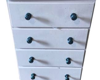 1040 - Painted 4 Drawer Cabinet w/ Contents (Description): Painted four drawer cabinet with contents included. The cabinet features decorative knobs on each drawer. Measures 31.5 inches high by 19.25 inches wide by 12 inches deep.