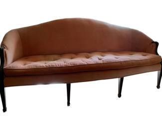 333 - Vintage Curved Camelback Sofa (Description): Pink upholstered sofa featuring a curved camelback silhouette with tufted cushion seat and dark wood frame with tapered legs. Measures 34 inches high by 72 inches wide by 28 inches deep.