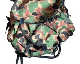686 - Folding Seat w/ Storage (Description): Folding seat with storage compartment. Features a camouflage pattern fabric with multiple pockets and buckle closures, mounted on a folding metal frame.