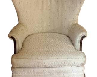 1028 - Upholstered Chair 40.5"x29"x30" (Description): Upholstered chair featuring a high wingback design with rolled arms accented by wood trim. The chair is covered in a patterned fabric and includes a skirted base. Measures 40.5 inches high by 29 inches wide by 30 inches deep.