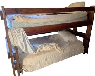 737 - Wood Bunk Bed w/ Bedding 52"x41"x82" (Description): Wooden bunk bed with bedding included. The frame features a rich wood finish with sturdy construction. Comes complete with mattresses, sheets, and pillows. Measures 52 inches wide by 41 inches deep by 82 inches tall.