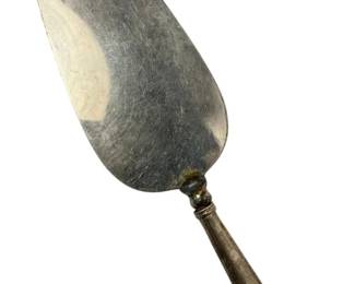 2010 - Sterling Handle Cake Server 9.5" (Description): Sterling handle serving knife measuring 9.5 inches in length. Features a classic design with a pointed blade suitable for serving.