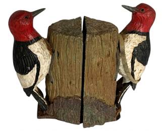 1065 - Woodpecker Bookends 6.5"x3.75"x2" (Description): Pair of wood rocker bookends featuring carved and painted woodpecker figures perched on tree stump bases. Each bookend measures 6.5 inches by 3.75 inches by 2 inches.