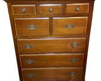 1140 - Chest of Drawers 49.5"x36"x20" (Description): Featuring a traditional design with brass bail pulls on the larger drawers and round knob pulls on the three smaller top drawers. The piece has a warm wood finish with a shaped apron and bracket feet. Measures 49.5 inches tall by 36 inches wide by 20 inches deep.